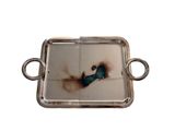 a silver tray with a picture of a bird on it