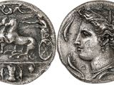 a silver coin with an image of a horse on it
