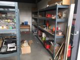 a room with a lot of shelves and tools in it