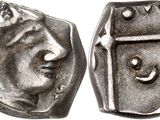 a close up of a coin with a face on it