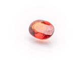 a close up of a red and orange oval shaped stone
