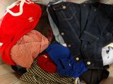 a pile of clothes sitting on top of a bed