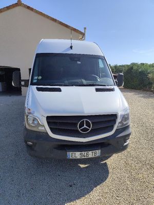 the white van is parked in front of a garage