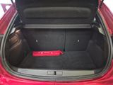 the trunk of a red car with a red speaker in the trunk