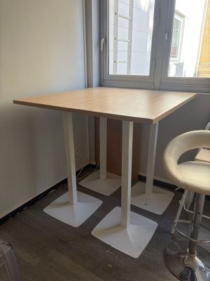 a small table and two chairs in the corner of a room