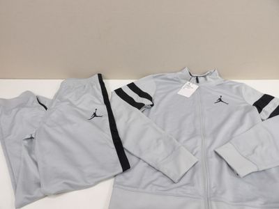 a close up of a white jacket and pants on a table
