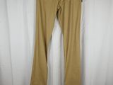 a pair of tan pants hanging on a white curtain