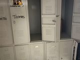 many white lockers in a room with graffiti on them