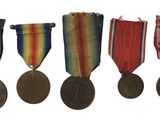 four medals are lined up in a row on a white background