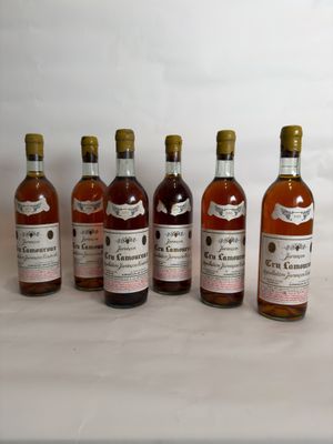 six bottles of wine are lined up on a table