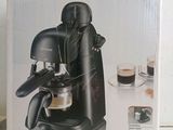 the box of the coffee machine is open on the table