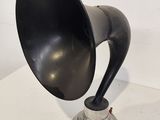 a black horn sitting on top of a white table