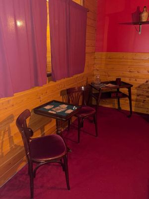 two chairs and a table in the corner of a room