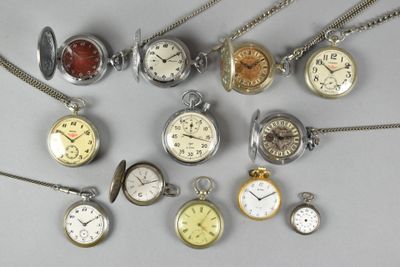 many different types of pocket watches on the table