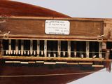 a wooden model of a musical instrument on display