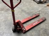 a red hand truck that is sitting in a warehouse