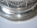 a close up of a silver object on a white surface