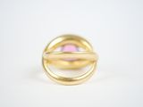 an image of a gold ring with a pink stone in it