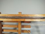 a close up of a wooden chair with a wooden seat