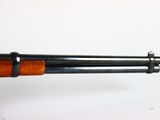 an old shotgun with a wooden handle on a white background