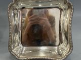 a silver plate with a mirror in it