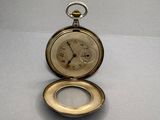 a pocket watch that is sitting on a table