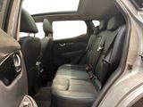 the back seats of a silver car with a black seat belt