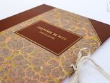 a book with a brown cover on a white table