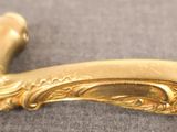 a close up of a gold plated handle on a table