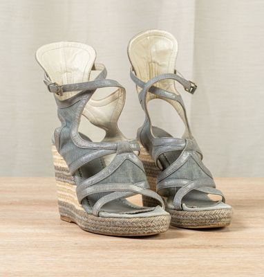 pair of women ' s wedged sandals on a wooden surface