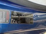 a close up of a mercedes benz logo on a blue car