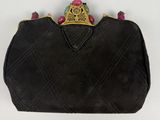 a black purse with a gold crown on top of it