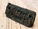 a small bronze plaque on top of an old book