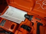 an orange box with a drill and other tools in it