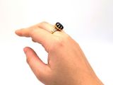 a person ' s hand with a ring on it ' s finger