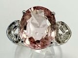 an image of a pink and white diamond ring on a white surface
