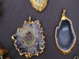 many different types of jewelry on display on a table