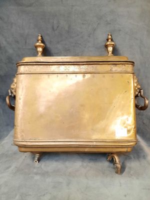 an antique brass box with handles and handles on a grey background
