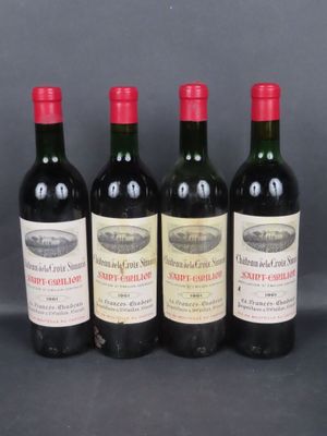 four bottles of wine are lined up on a table