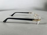 pair of black and gold rimmed eyeglasses on a white surface