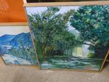deux tableaux représentant des arbres et une rivière sont posés par terre