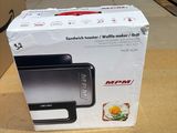 packaging of a black and white microwave sitting on top of a wooden table