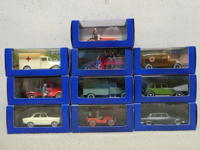 many different toy cars in the boxes on the table