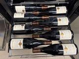 many bottles of wine sitting on a rack in a wine cellar