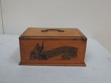 an old wooden box sitting on top of a white table