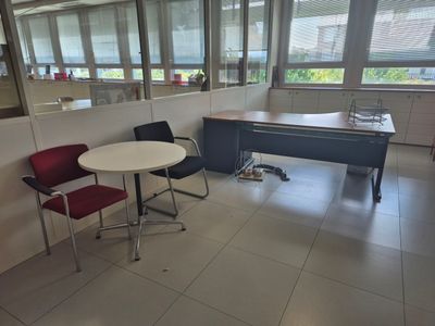 a room with a table, chairs, and a piano in it