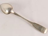 a spoon that is sitting on a white surface