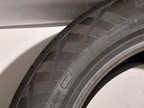 a close up of a tire on the side of a white car