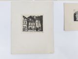 three black and white drawings on a white wall next to a picture of a house