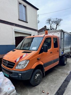 an orange truck that is parked in front of a building
